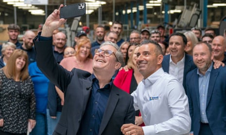Keir Starmer takes a selfie alongside chief operating officer Martin Linden and staff during a visit to Window Supply Company in Bathgate, West Lothian.