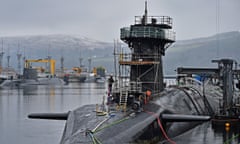 Royal Navy security personnel stand guard on HMS Vigilant at the Faslane base in Clyde, Scotland in 2016. 