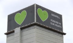 Top of Grenfell Tower block, with text attached to part of the building saying: Grenfell forever in our hearts