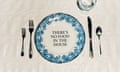 An artwork by the British artist Corbin Shaw features a  table setting including ornate cutlery and a plate with a blue floral rim and the slogan 'there's no food in the house'