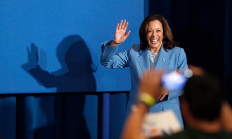 woman wearing blue suit smiles and waves