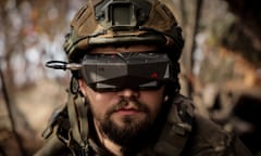A serviceman of Separate 14th Regiment of Armed Forces of Ukraine, call-sign Spokiy, wears glasses to operate an FPV strike drone