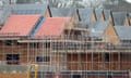 New homes under construction. Partially build new homes with scaffolding outside.