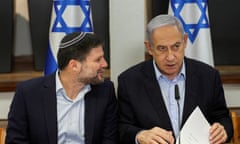 Two men sat side by side with two Israeli flags behind