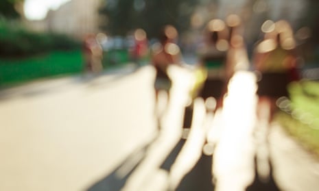 Blurred people background in magic sunset light with long shadows.