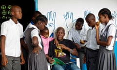 A teacher with a group of children at the Oscar Romero school for the deaf in Tubmanburg.