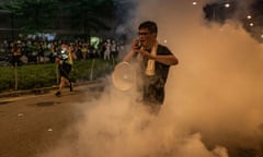 A protester reacts to police teargas outside the Legislative Council complex on Tuesday.