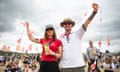 Lucy and Joe - two football fans wearing England shirts holding up some three lions bunting at Glastonbury