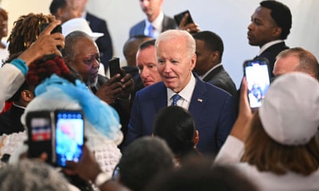 people surround white man wearing blue suit and blue tie