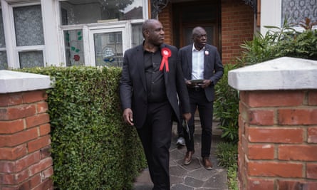 David Lammy and Bayo Alaba walking away from someone’s house