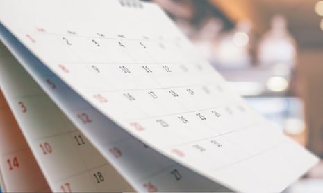 Close up white paper desk calendar with blurred bokeh background appointment and business meeting concept