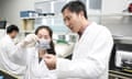 He Jiankui (right) guides a laboratory staff member at a genomics lab in Shenzhen, China, in 2016