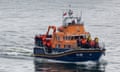 Migrants are brought into Dover Port by a RNLI lifeboat after being picked up in the English Channel.