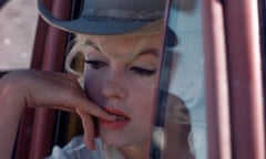 Marilyn Monroe shot close up, leaning out the window of a truck, wearing a stetson hat, looking thoughtful and biting a fingernail