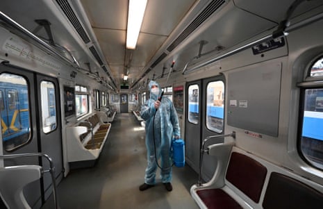 An employee wearing a protective suit disinfects a metro carriage in Kiev, Ukraine.