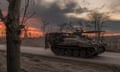 A Ukrainian serviceman drives a British FV103 Spartan armoured personnel carrier on a road that leads to the town of Chasiv Yar in the Donetsk region.