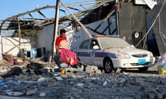 FILE PHOTO: A migrant picks up clothes from among rubble at a detention centre for mainly African migrants that was hit by an airstrike in the Tajoura suburb of the Libyan capital of Tripoli<br>FILE PHOTO: A migrant picks up clothes from among rubble at a detention centre for mainly African migrants that was hit by an air strike in the Tajoura suburb of the Libyan capital of Tripoli, July 3, 2019. REUTERS/Ismail Zitouny/File Photo