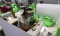 Garment workers in Myanmar work wearing face mask and shields to help curb the spread of Covid-19.