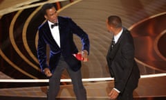 Chris Rock reacts after being hit by Will Smith.