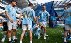 Kyle Walker with the trophy as the City players celebrate winning the title in May 2024