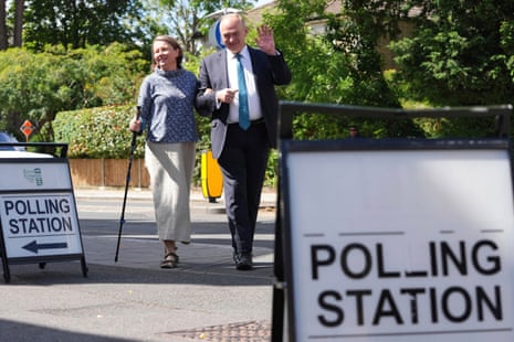 Britain's LibDem party leader Ed Davey and his wife Emily Davey wave to the media in Kingston, London.