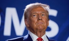 close-up of man wearing blue suit and red tie