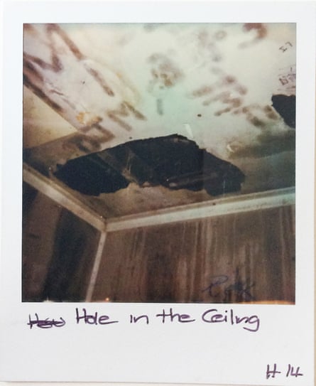 A Polaroid photo of a hole in the ceiling of a house