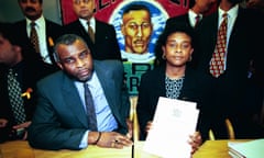 Neville and Doreen Lawrence at a press conference holding a copy of an inquiry.