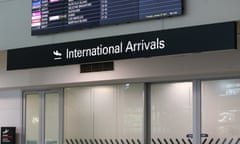 International arrivals sign above doors at an airport