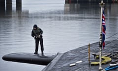 Royal Navy security personnel stand guard on HMS Vigilant at its Clyde naval base in 2016
