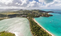 Aerial view of a lagoon on the Caribbean island of Antigua a thin line of sand divides the small salt basin from the sea, Antigua, Leeward Islands, West Indies, Caribbean, Central America<br>GettyImages-530319294