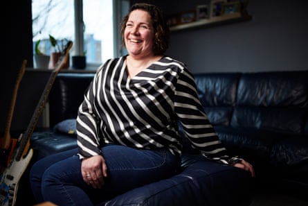 Lucy Keighley at home in Stockton-on-Tees, sitting on a sofa, laughing