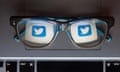 Twitter logo reflected in a pair of glasses.