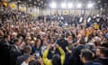 big crowd gathers around harris in high school gym