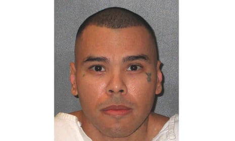 Man in white prison uniform in mugshot photo