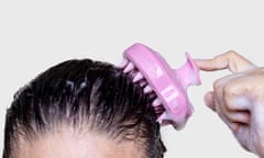 woman using silicone pink shampoo brush for scalp massage hair growth stimulation isolated