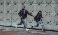 Kane Robinson as Izi and Jedaiah Bannerman as Benji running along a street in a scene from The Kitchen