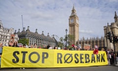 Protesters hold a "stop Rosebank" sign outside of Westminster