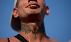 A faithful with a tattoo of a cross on his neck walks towards the Cathedral to attend a Mass celebrating 15 years of the Familia Grande Hogar de Cristo organization that works to rehabilitate drug addicts and marking Francis' 10th year anniversary as Pope, in Lujan, Argentina, Saturday, March 11, 2023. Francis left Argentina in February 2013 to attend the conclave that elected him as the successor to Benedict XVI on March 13. (AP Photo/Natacha Pisarenko)