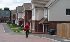 a postman delivers mail at a new-build housing estate