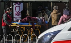 An elderly woman on a stretcher is wheeled into the fever clinic at a hospital in Beijing, Sunday, Dec. 11, 2022. Facing a surge in COVID-19 cases, China is setting up more intensive care facilities and trying to strengthen hospitals as Beijing rolls back anti-virus controls that confined millions of people to their homes, crushed economic growth and set off protests. (AP Photo/Andy Wong)