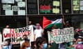 Students stand outside a building holding signs reading 'No more universities in Gaza' and 'LSE disclose invest'