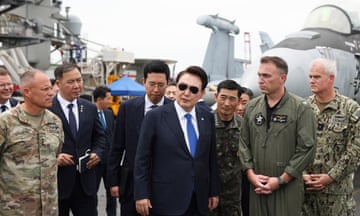 The South Korean president, Yoon Suk-yeol, boards the USS Theodore Roosevelt aircraft carrier during the trilateral ‘Freedom Edge’ military exercise.