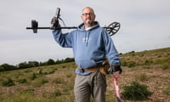 Rob Abbott, a metal detectorist, photographed in a field in Essex.