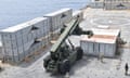 US Navy personnel construct a pier to assist aid to Gaza in the Mediterranean Sea.