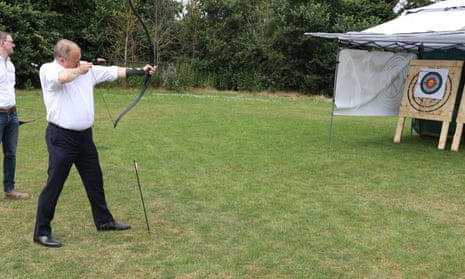 Ed Davey trying out archery during the Liberal Democrats election trail