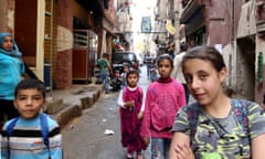 Syrian children pose for a photo on a narrow street in the Shatila Palestinian refugee camp on the southern outskirts of Beirut