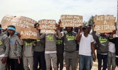 Migrants hold placards during the visit of António Guterres, the UN secretary general, to Ain Zara detention centre for migrants in the Libyan capital Tripoli