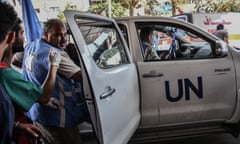 aid workers getting into a car marked UN