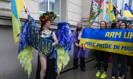 A drag queen waves a Ukraine flag at the Kyiv pride march. 